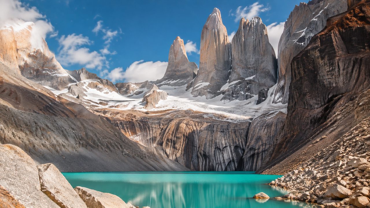 The granite towers of Torres del Paine rising above a grey glacial lake in Chilean Patagonia